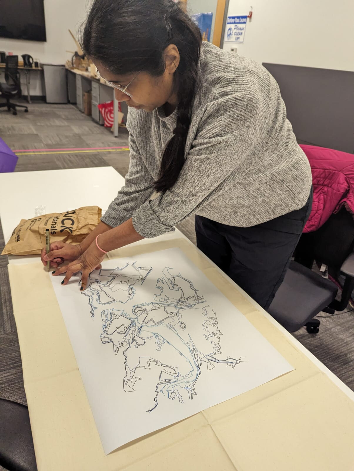 Saumya hand-tracing the composite Boston map onto paper